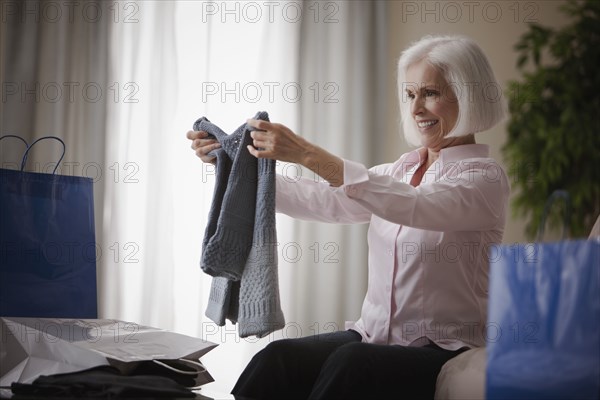 Caucasian woman holding new sweater