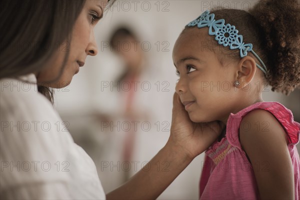 Mother comforting daughter in doctor's office