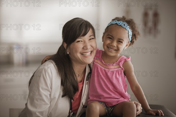 Doctor and girl smiling in doctor's office