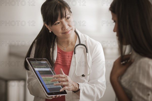 Doctor showing digital tablet to patient