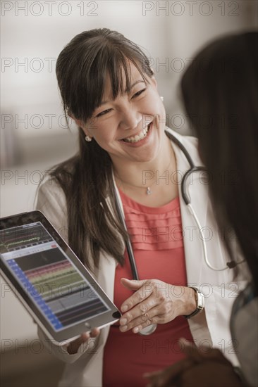 Doctor showing digital tablet to patient