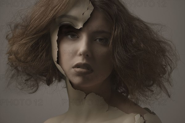 Caucasian woman with broken plastic skin