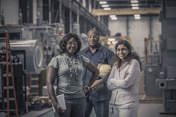 Workers standing together in factory