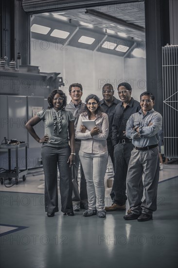 Workers standing together in factory