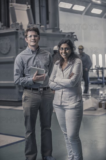 Workers standing together in factory