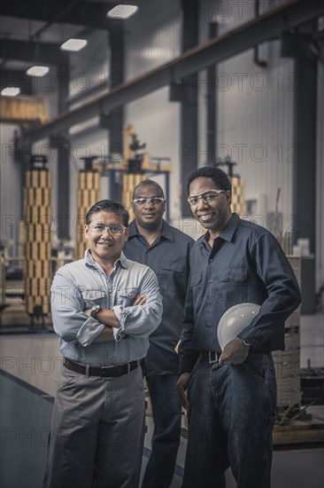 Workers standing together in factory