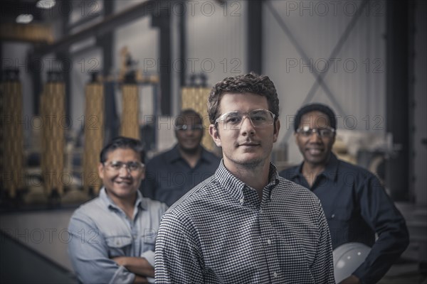 Workers standing together in factory