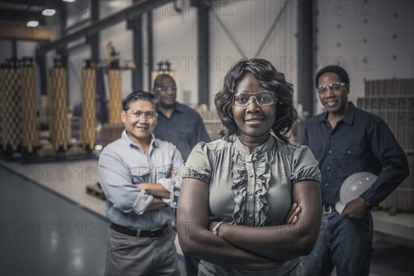 Workers standing together in factory