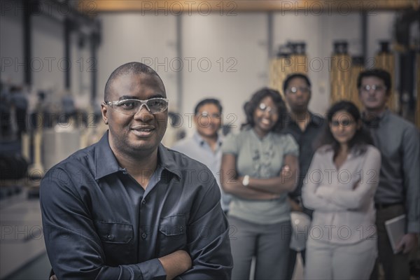 Workers standing together in factory