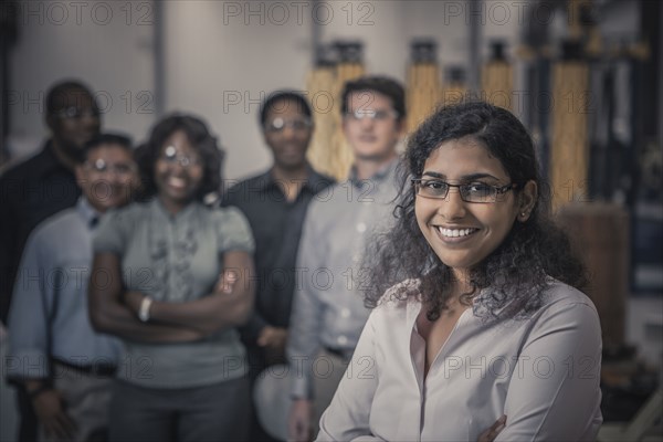 Workers standing together in factory