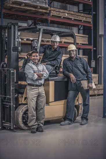 Workers with forklift in factory