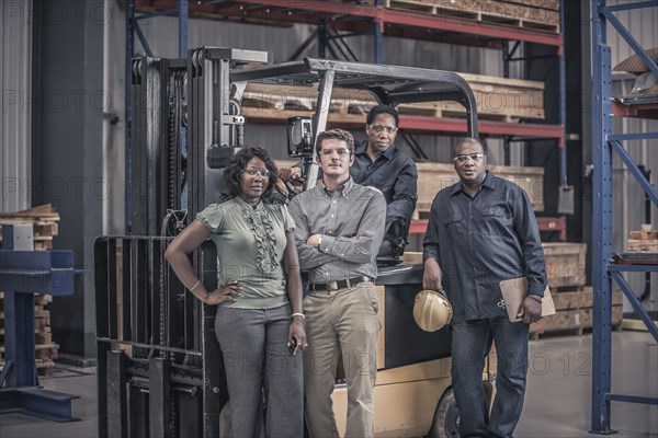 Workers with forklift in factory