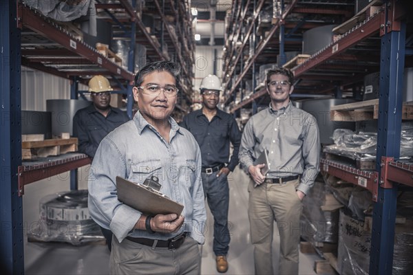 Workers standing together in factory