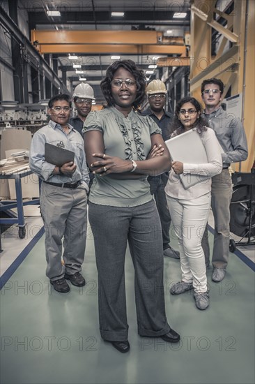 Workers standing together in factory