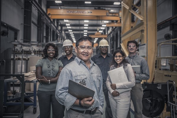 Workers standing together in factory