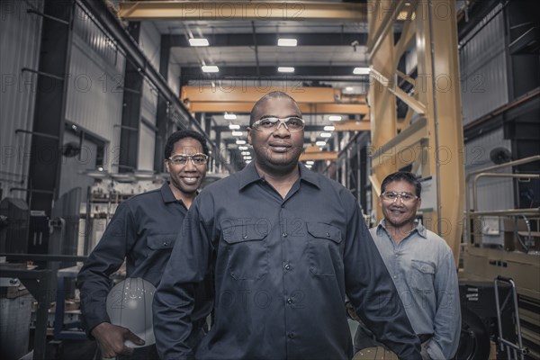 Workers standing together in factory