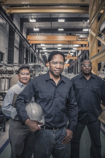 Workers standing together in factory