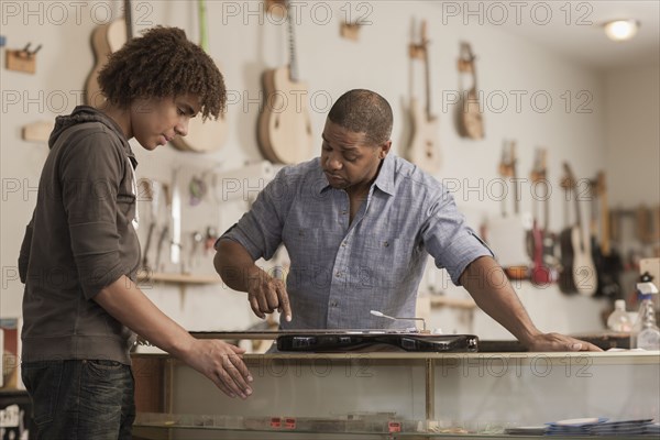 Father and son in music workshop