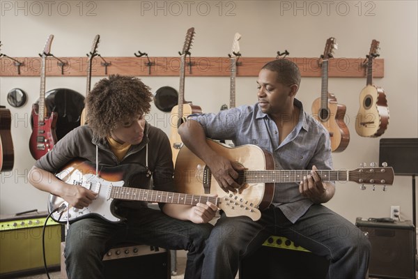 Father and son playing guitars together