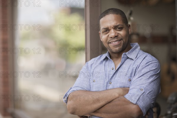 Native American man with arms crossed