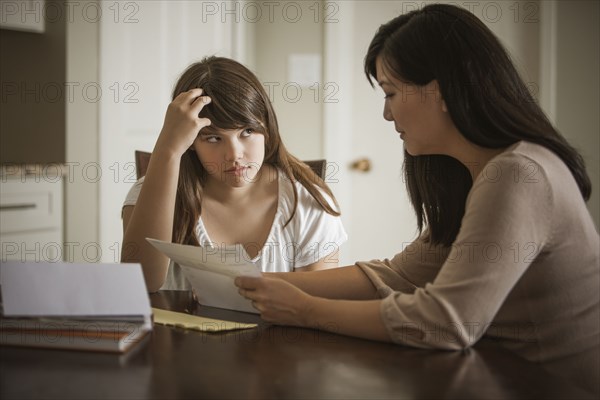 Mother helping daughter with homework