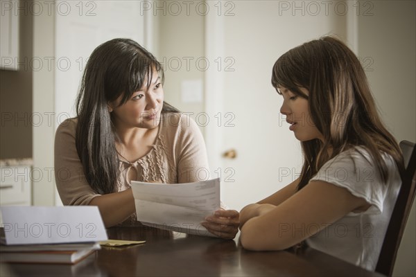 Mother helping daughter with homework