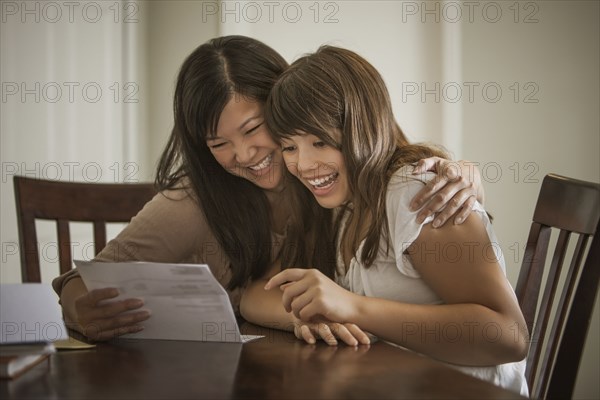 Mother helping daughter with homework