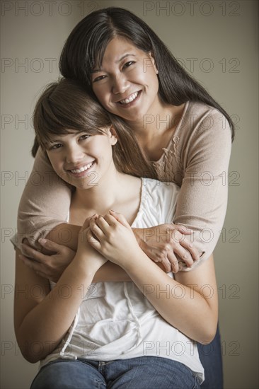 Mother and daughter hugging