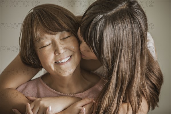 Woman kissing grandmother