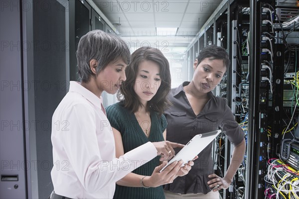 Businesswomen working together in server room