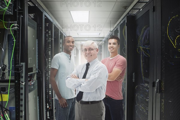 Businessmen standing in server room