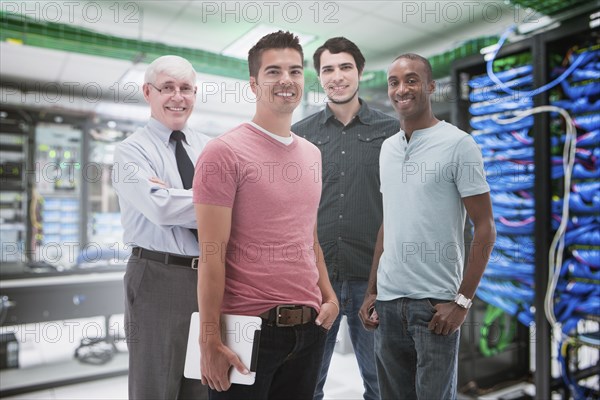 Businessmen standing in server room