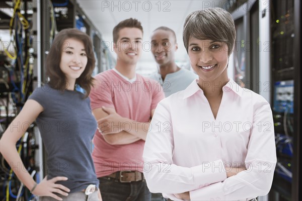 Business people standing in server room