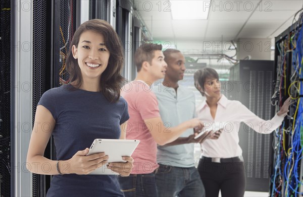 Business people standing in server room