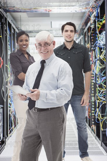 Business people standing in server room