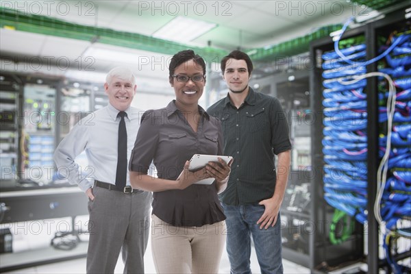 Business people standing in server room