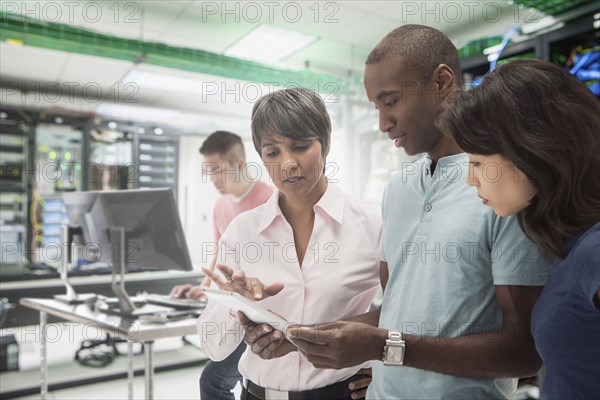 Business people working in server room