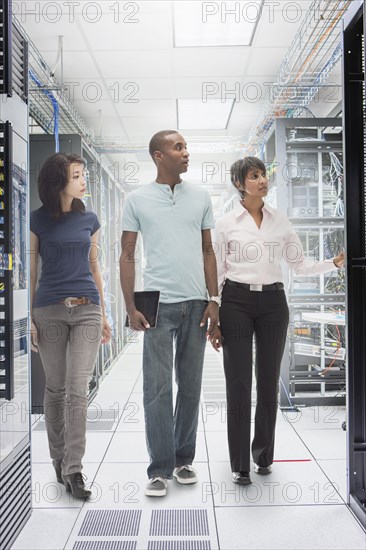 Business people working in server room