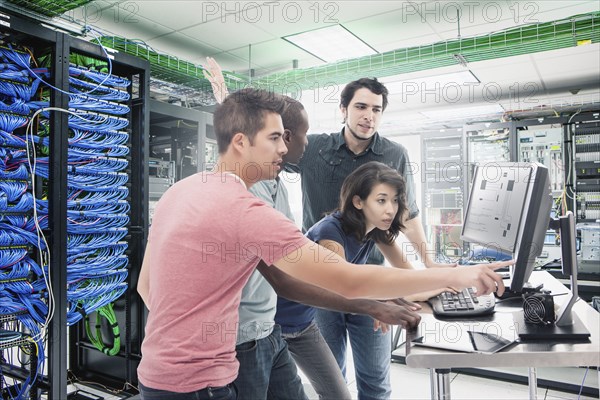 Business people working in server room