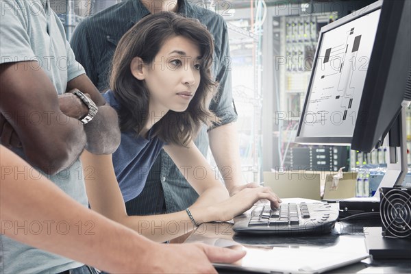 Business people working in server room