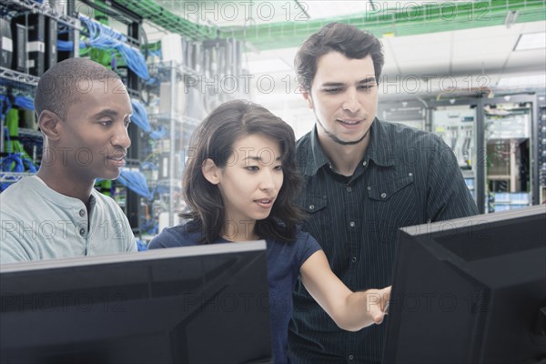 Business people working in server room