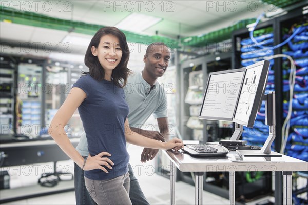 Business people working in server room