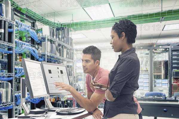 Business people working in server room