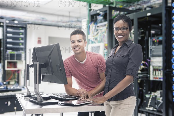 Business people working in server room