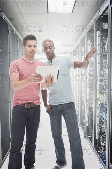 Businessmen working in server room