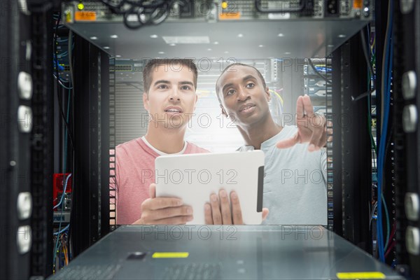 Businessmen working in server room