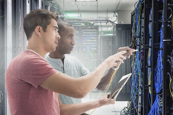 Businessmen working in server room