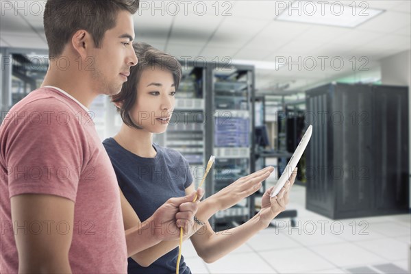 Business people working in server room