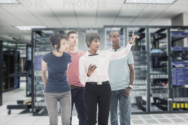 Business people working in server room