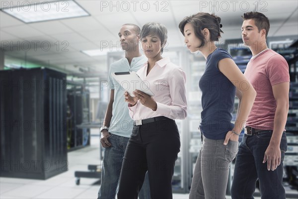 Business people working in server room